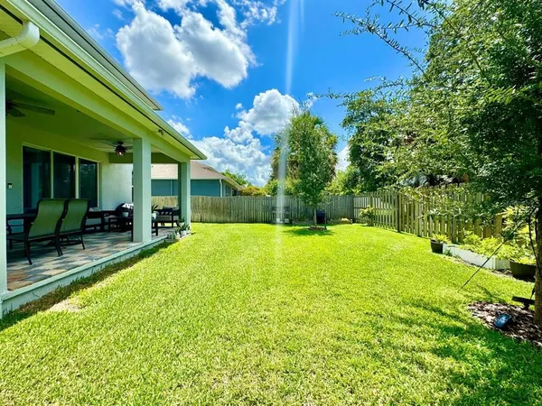 a swimming pool with outdoor seating and yard