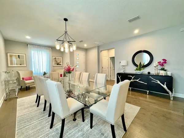 a view of a dining room with furniture and a chandelier