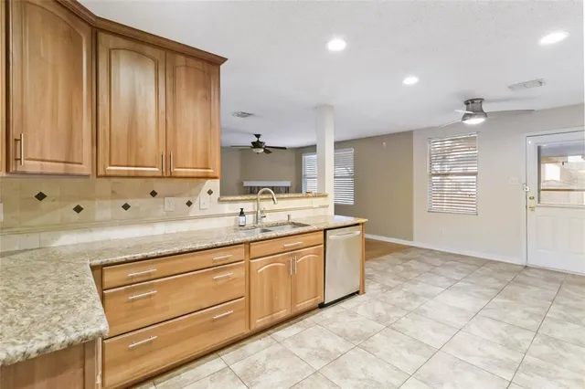 a view of a kitchen with sink and mirror