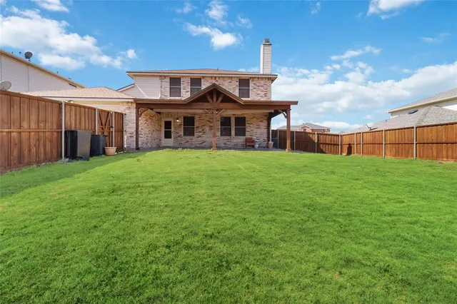 a view of a yard with a house in the background