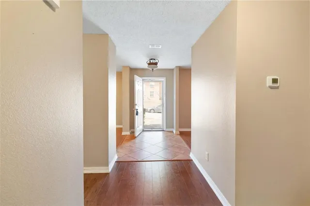 a view of a hallway with wooden floor