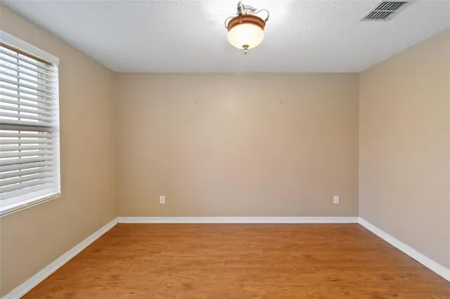 a view of a room with wooden floor and window