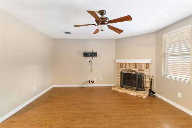 a view of a livingroom with a ceiling fan and window