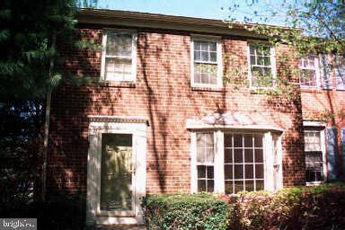 front view of a brick house with a large window