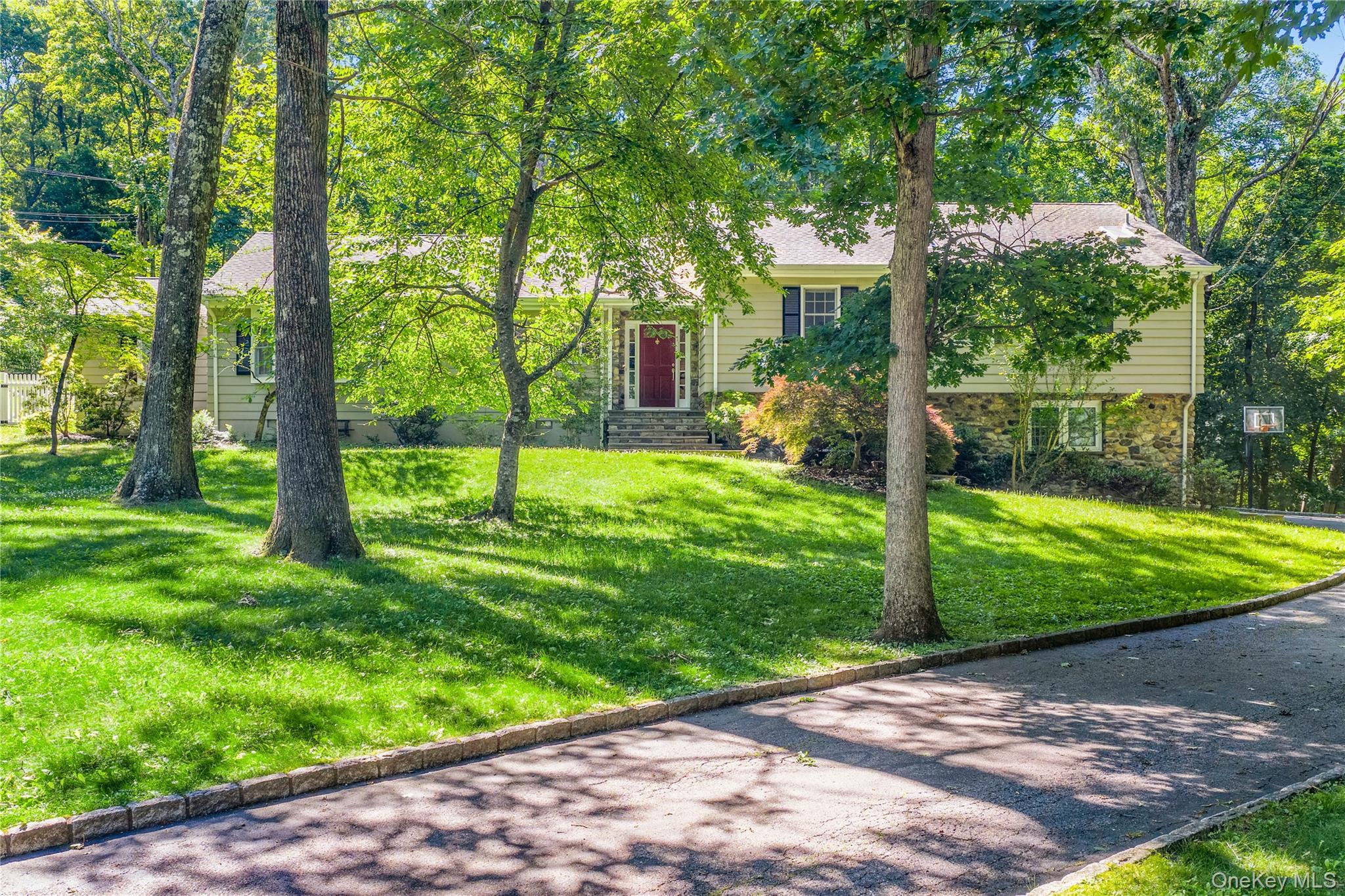 105 Cross Ridge Road Chappaqua, NY 10514 - Photo 2 of 43 The stone and clapboard exterior is shaded by towering trees and lush lawns