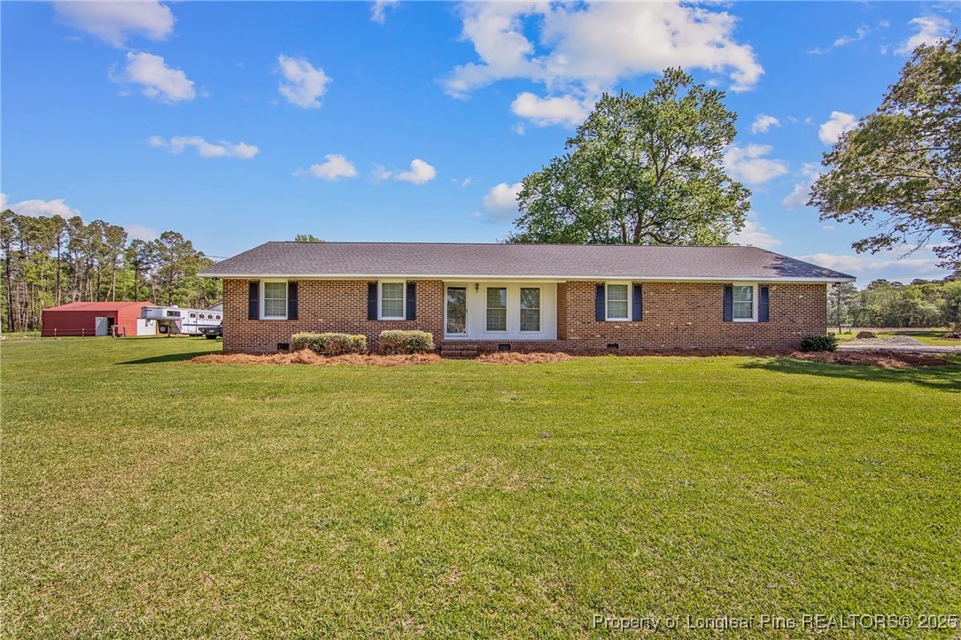 40 Kinlaw Road Lumberton, NC 28358 - Photo 1 of 50 a front view of a house with swimming pool having outdoor seating