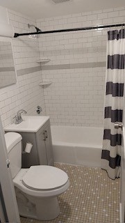 589 Broadway, Unit D Revere, MA 02151 - Photo 2 of 3 a bathroom with a sink toilet and shower