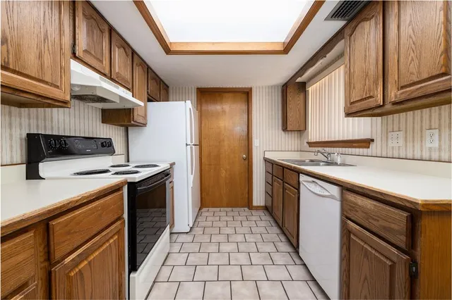 a kitchen with stainless steel appliances granite countertop a stove and a sink