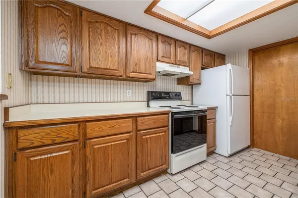 a kitchen with stainless steel appliances granite countertop a refrigerator and cabinets