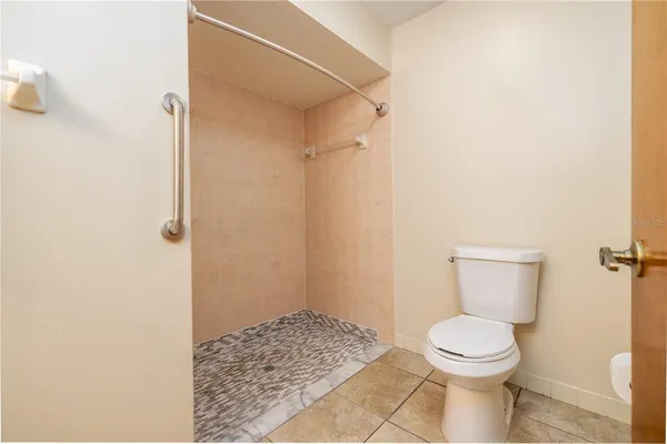 a bathroom with a toilet and a shower