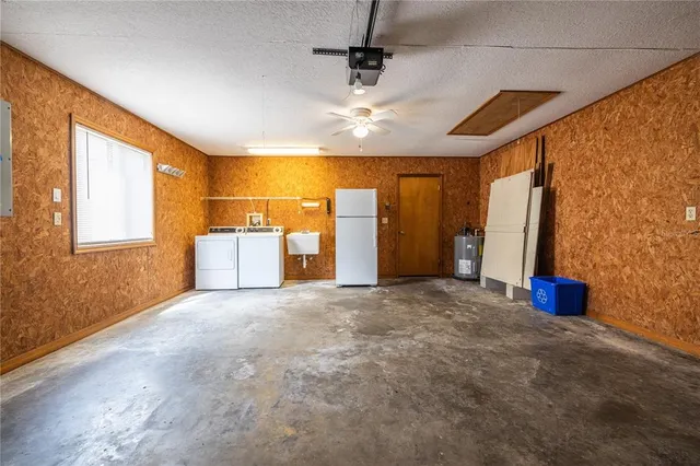 a view of a livingroom with furniture and chandelier fan
