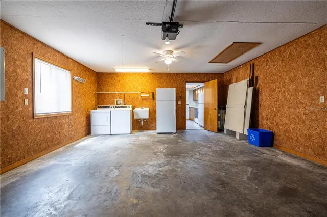 a view of a livingroom with furniture and chandelier fan