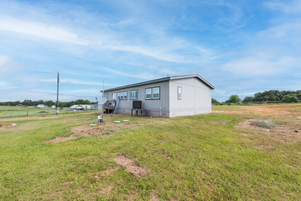 859 Ivy Switch Road Luling, TX 78648 - Photo 24 of 29 Back of house with a lawn