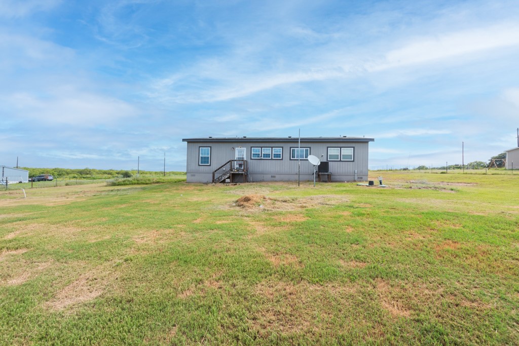 859 Ivy Switch Road Luling, TX 78648 - Photo 25 of 29 Back of house with crawl space, a lawn, and a rural view