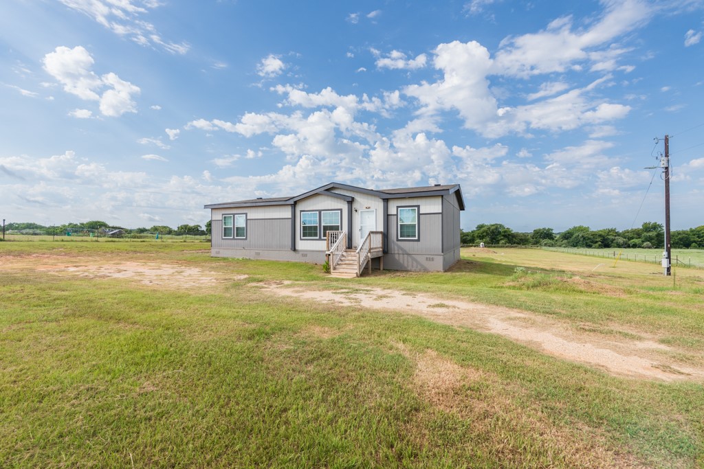 859 Ivy Switch Road Luling, TX 78648 - Photo 3 of 29 Manufactured / mobile home featuring crawl space, a front lawn, and a rural view