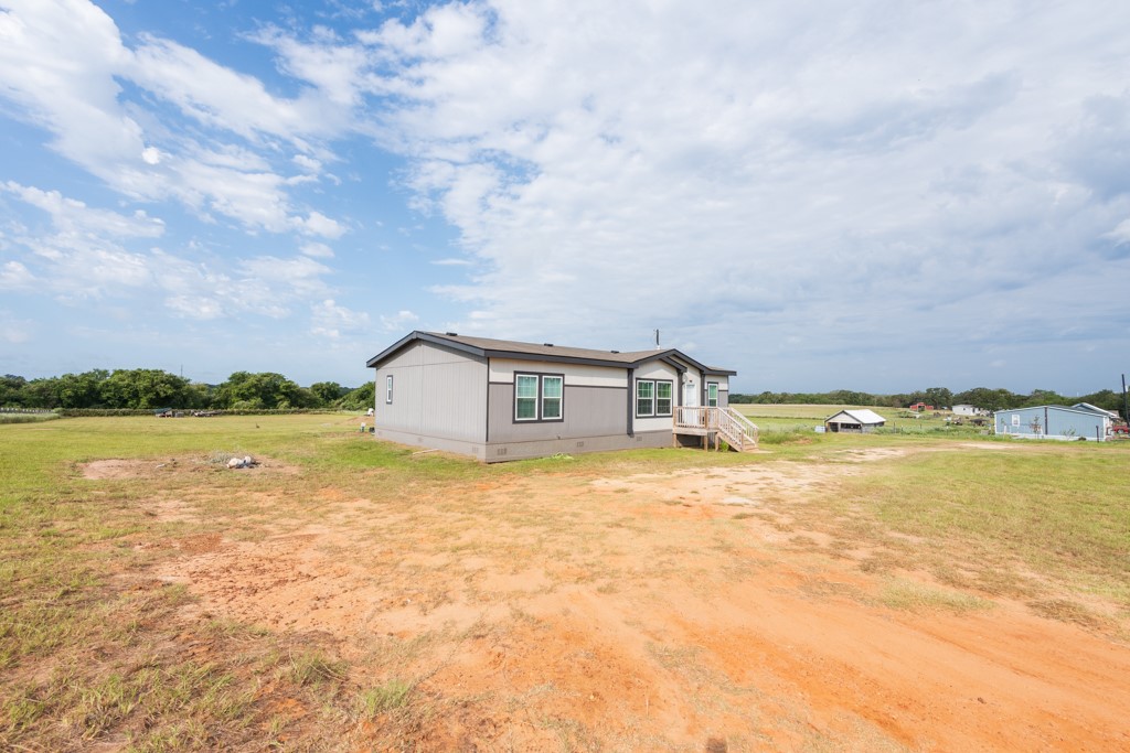 859 Ivy Switch Road Luling, TX 78648 - Photo 4 of 29 View of side of home featuring a yard and crawl space