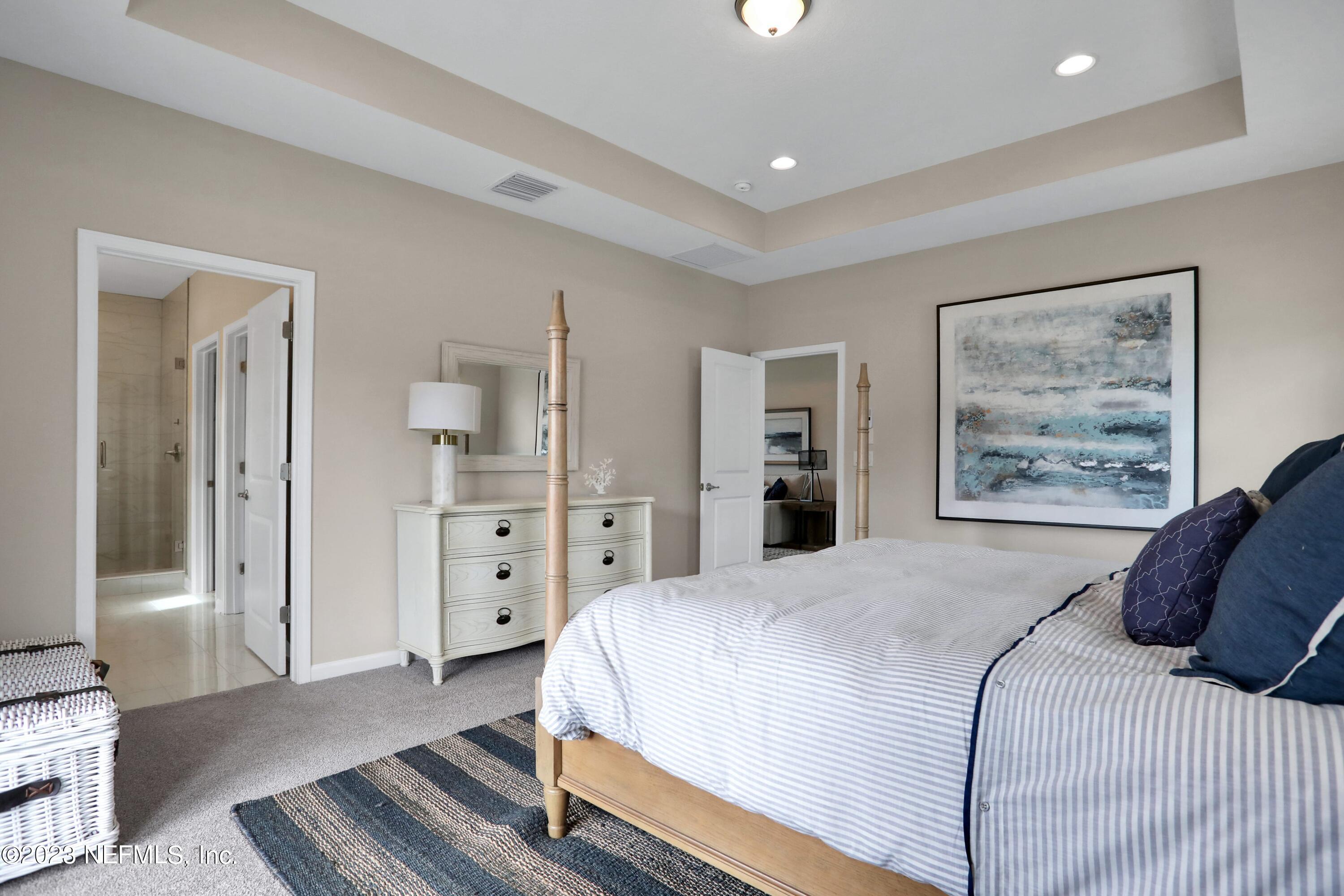 494 Archstone Way St. Augustine, FL 32092 - Photo 18 of 67 a bedroom with a large bed and a painting on the wall