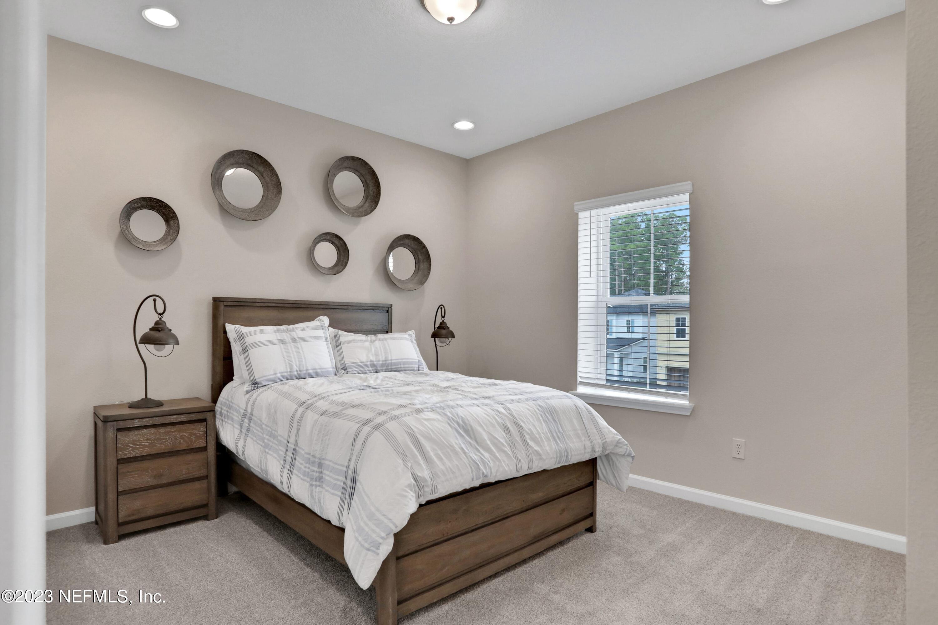 494 Archstone Way St. Augustine, FL 32092 - Photo 22 of 67 a bedroom with a bed and a window