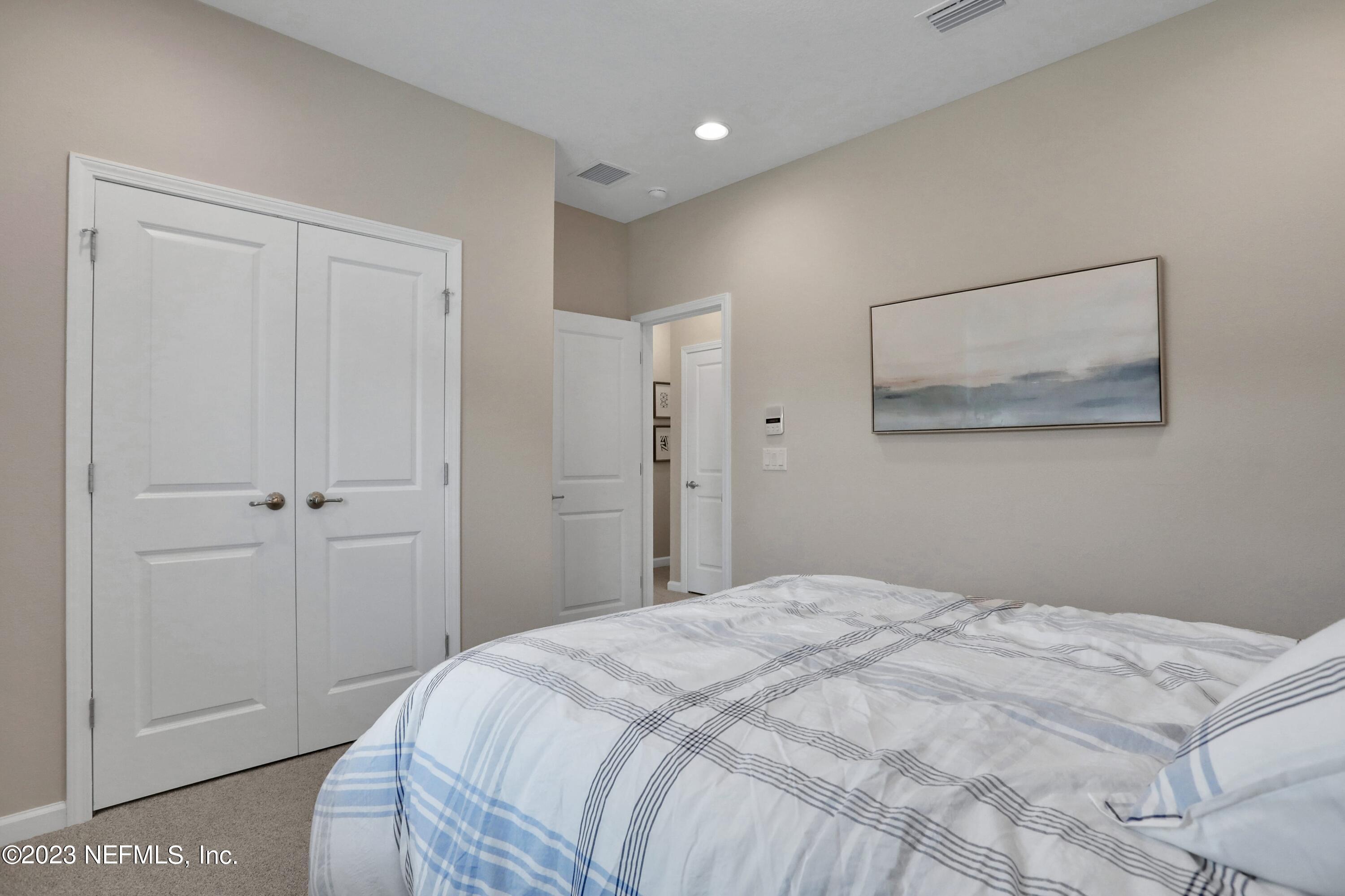 494 Archstone Way St. Augustine, FL 32092 - Photo 23 of 67 a bedroom with a bed and a painting on the wall