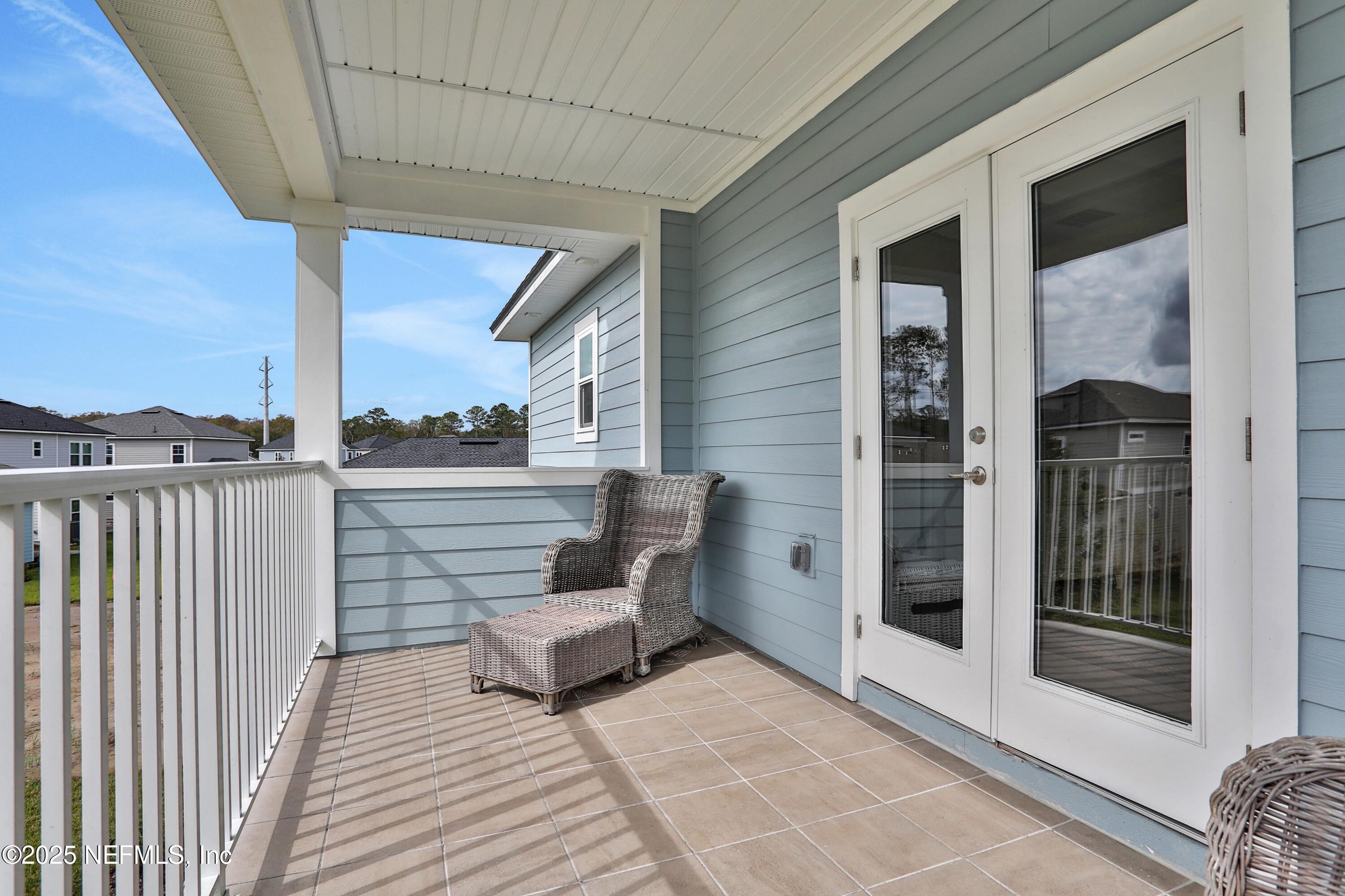 494 Archstone Way St. Augustine, FL 32092 - Photo 30 of 67 a view of a balcony with furniture and wooden floor