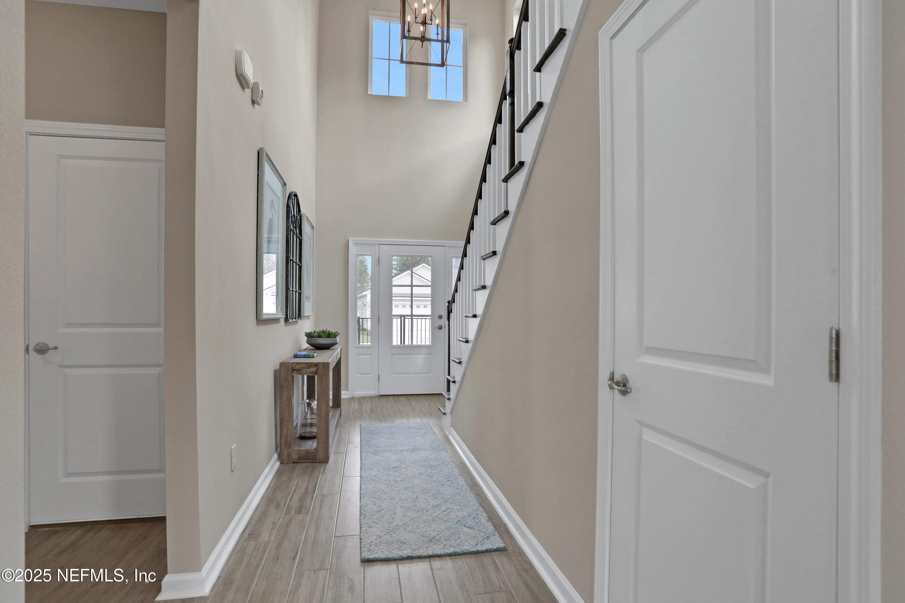 494 Archstone Way St. Augustine, FL 32092 - Photo 33 of 67 a view of a hallway with wooden floor and staircase