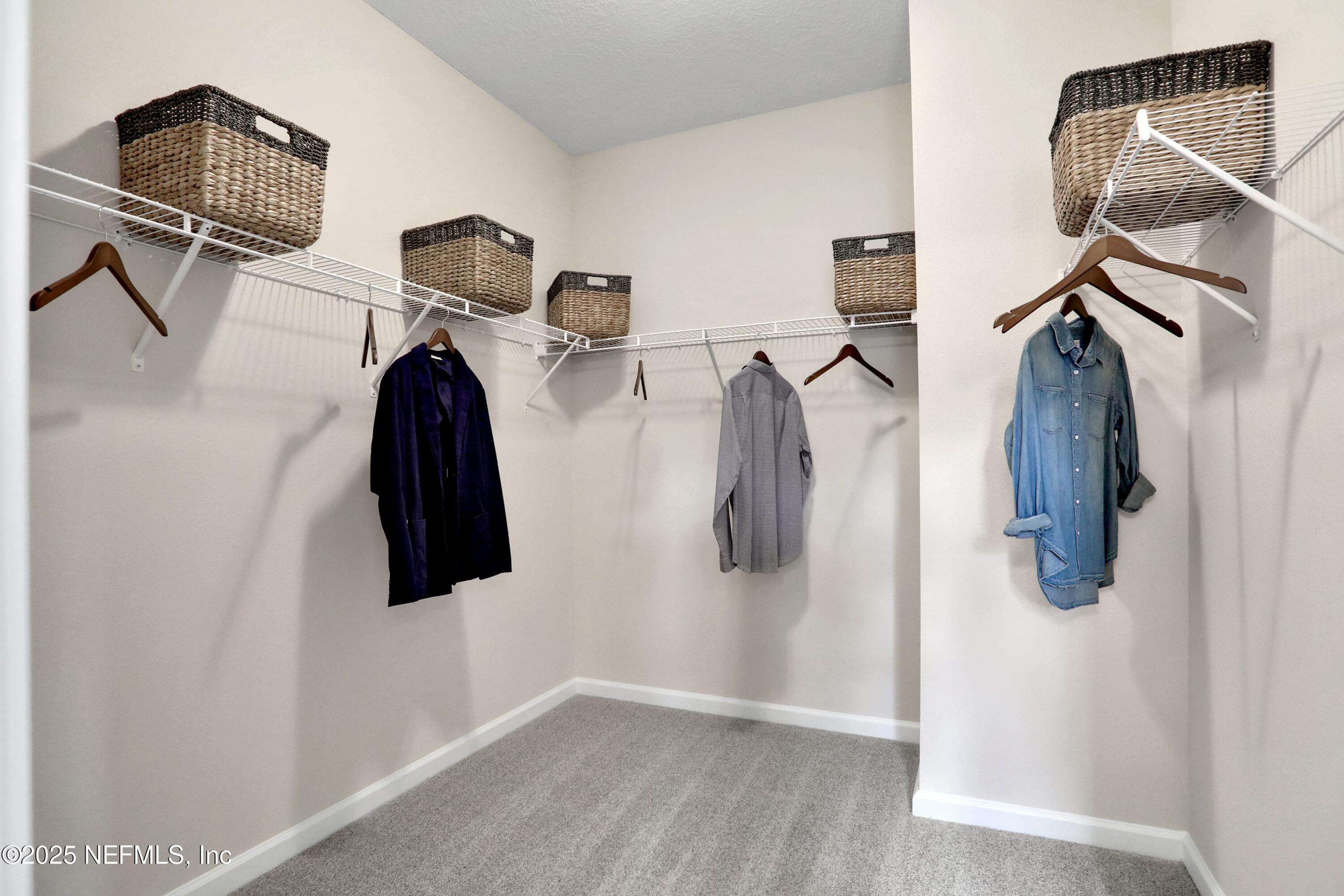 494 Archstone Way St. Augustine, FL 32092 - Photo 50 of 67 a view of walk in closet with clothes and shoes