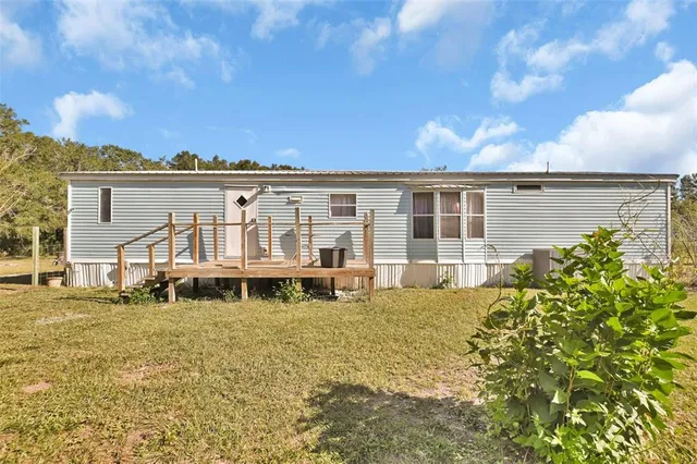 a view of a house with pool and sitting area