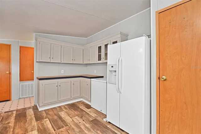 a kitchen with a refrigerator a sink and cabinets