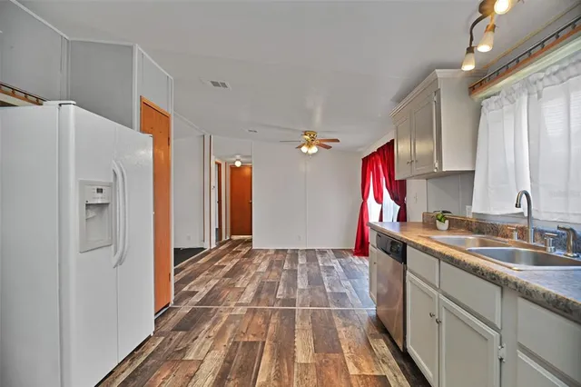 a kitchen with a sink and a refrigerator