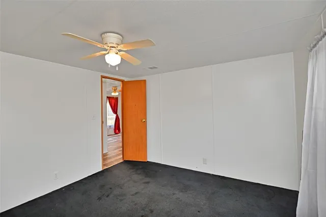 an empty room with closet and window