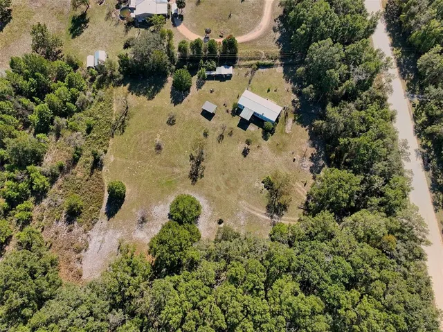 an aerial view of residential house with outdoor space