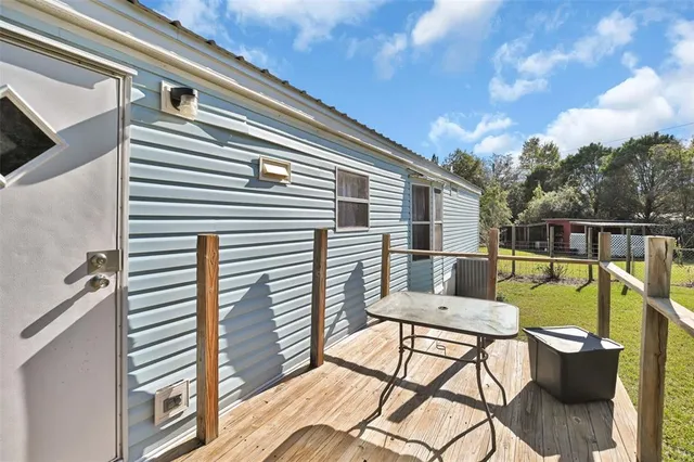 a balcony with furniture and a potted plant