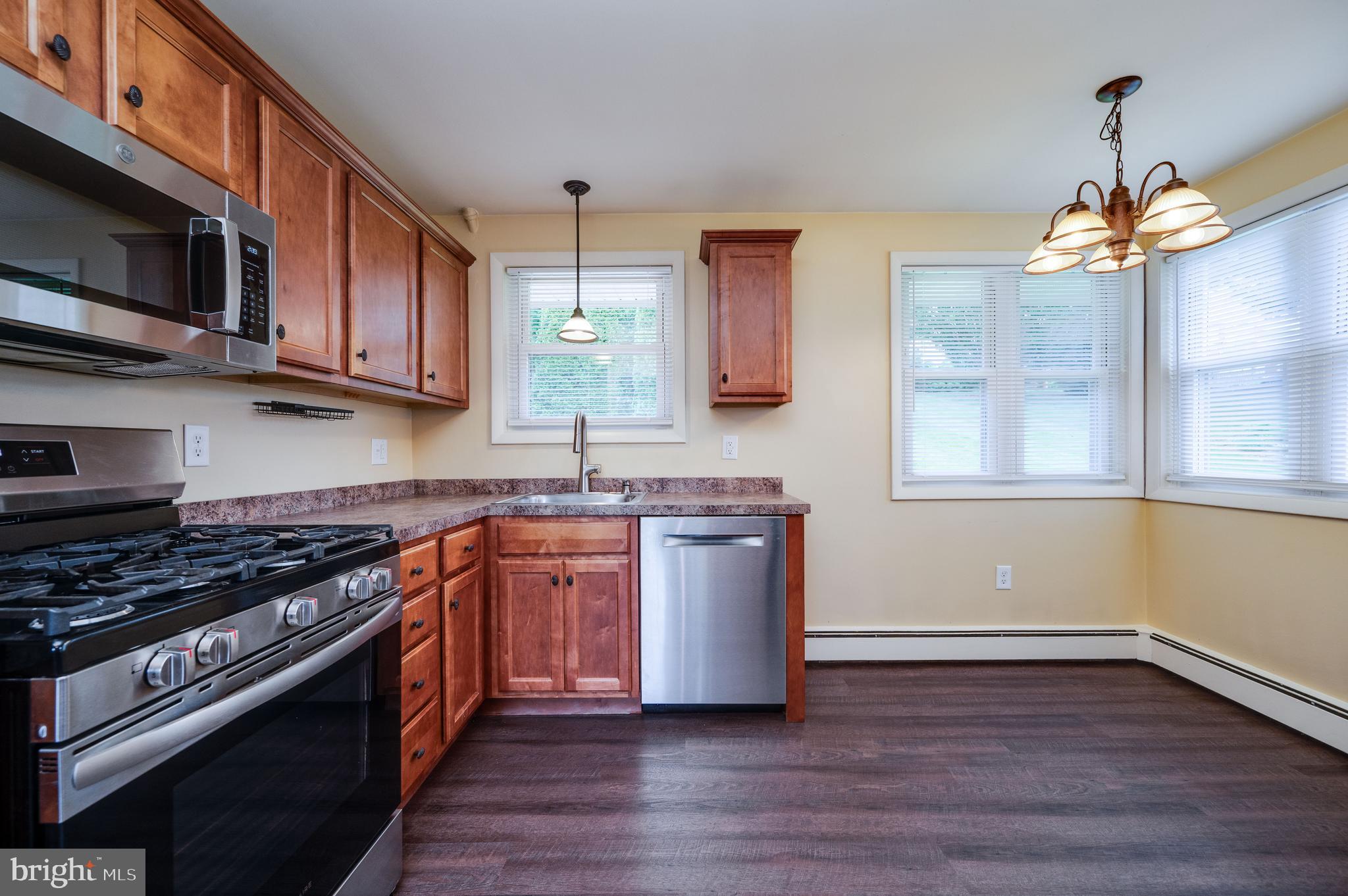 1392 New Holland Road Reading, PA 19607 - Photo 12 of 27 a kitchen with stainless steel appliances granite countertop a stove a sink and a microwave