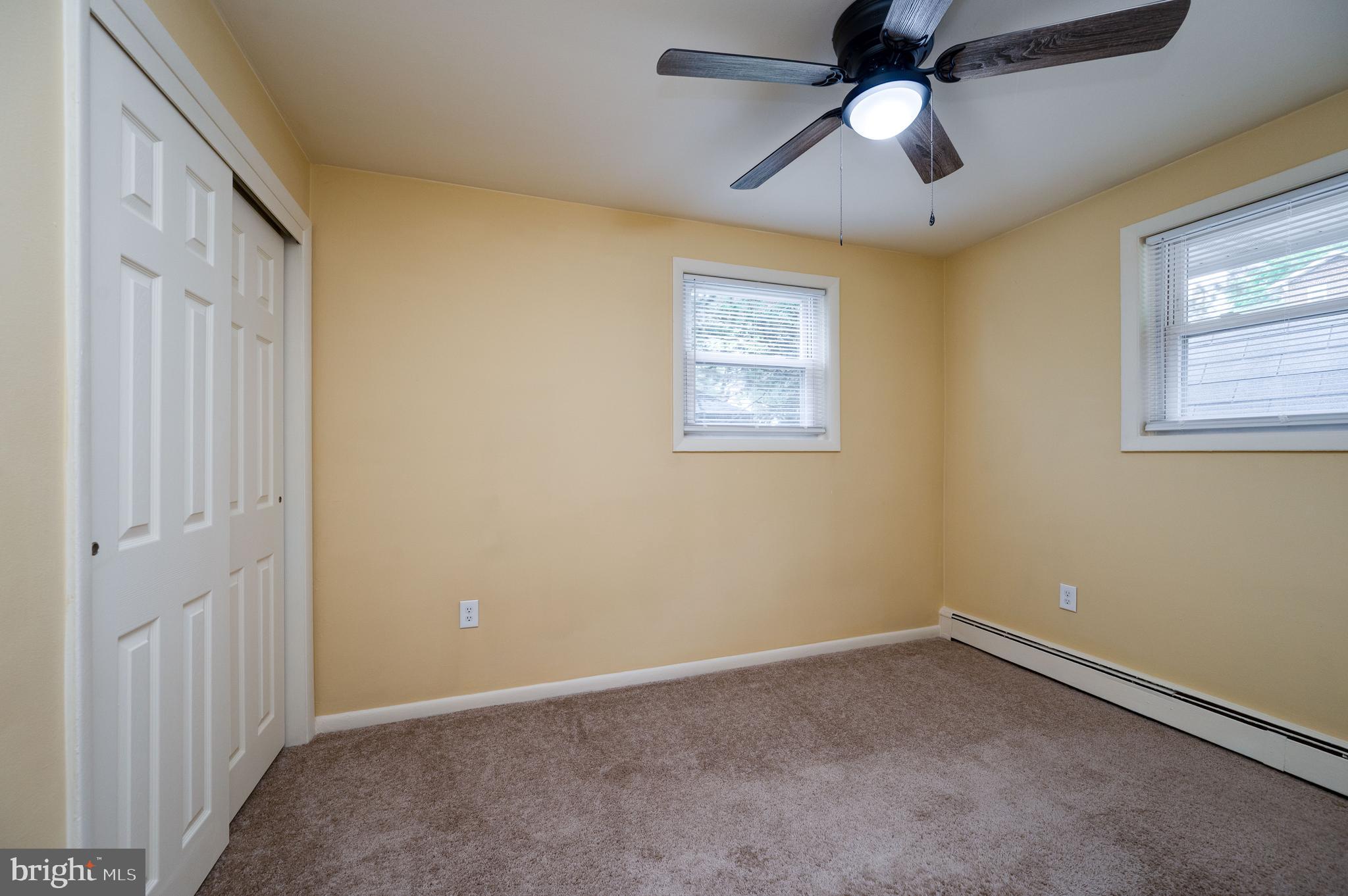 1392 New Holland Road Reading, PA 19607 - Photo 18 of 27 en empty room with windows and ceiling fan