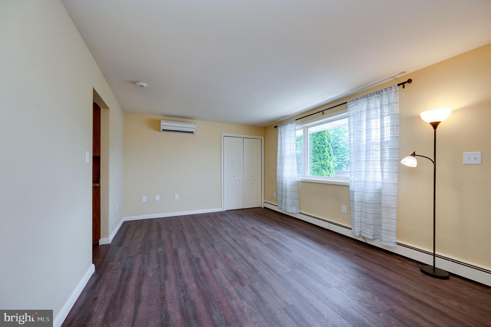 1392 New Holland Road Reading, PA 19607 - Photo 9 of 27 an empty room with wooden floor and a window