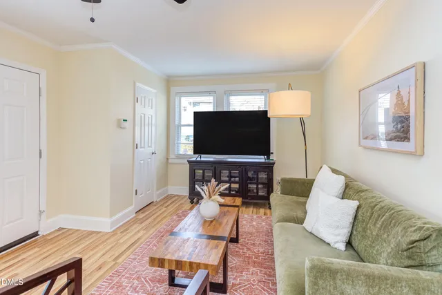 a bedroom with a bed and a lamp on dresser