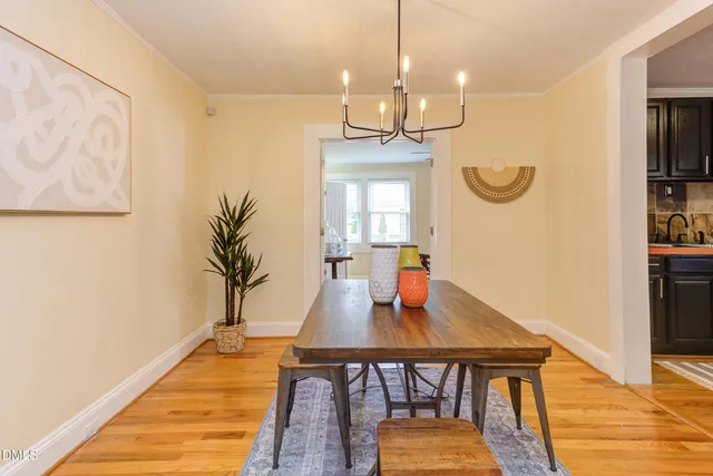 a living room with furniture a flat screen tv and a window