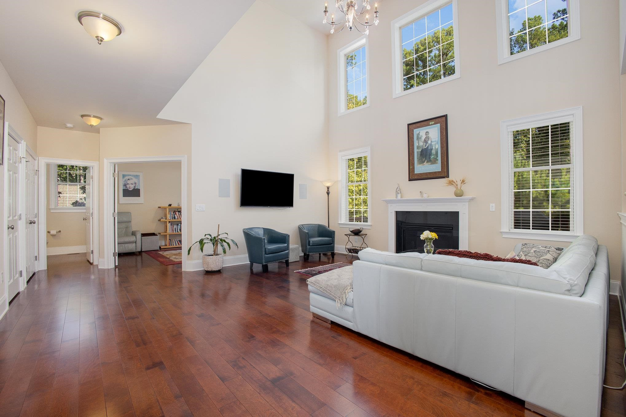 610 Swift Creek Crossing Durham, NC 27713 - Photo 13 of 48 a living room with furniture a fireplace and a flat screen tv
