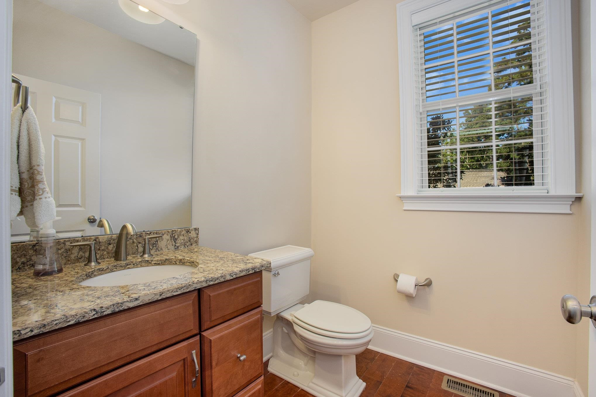 610 Swift Creek Crossing Durham, NC 27713 - Photo 18 of 48 a bathroom with a granite countertop toilet a sink and a mirror