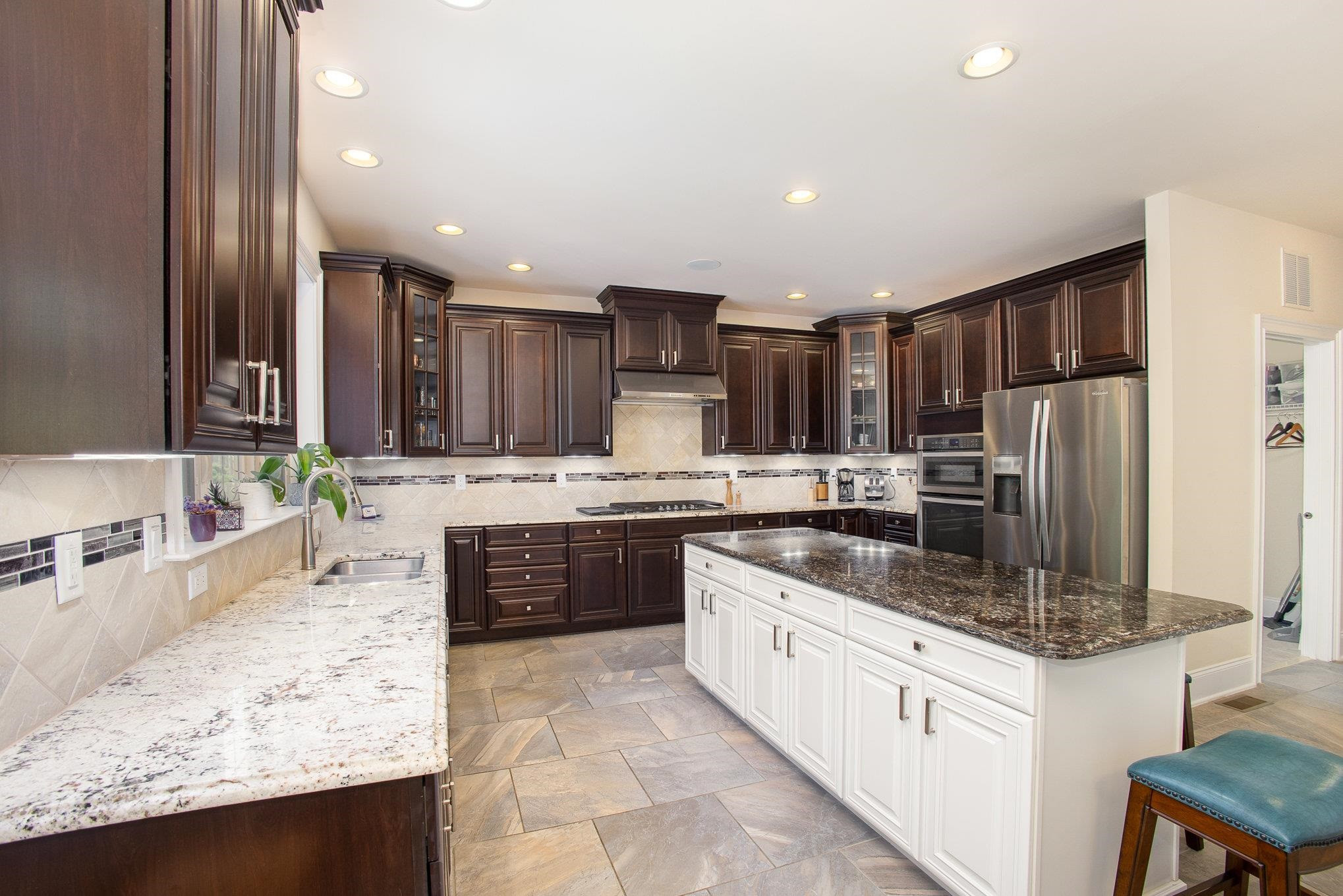 610 Swift Creek Crossing Durham, NC 27713 - Photo 19 of 48 a large kitchen with kitchen island granite countertop a sink refrigerator and cabinets
