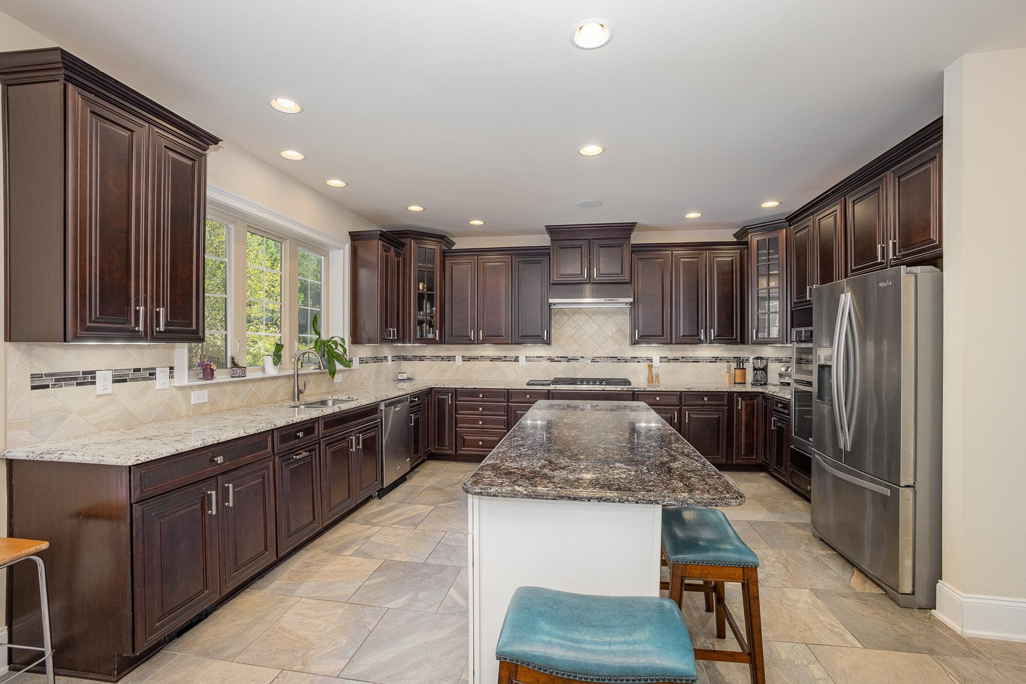 610 Swift Creek Crossing Durham, NC 27713 - Photo 22 of 48 a large kitchen with stainless steel appliances granite countertop a sink stove and refrigerator