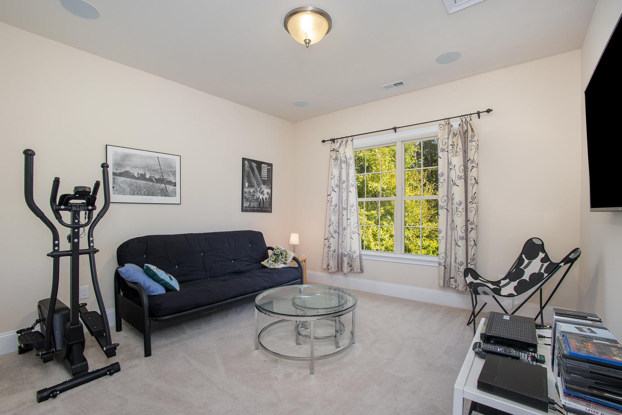 610 Swift Creek Crossing Durham, NC 27713 - Photo 29 of 48 a living room with furniture a window and a flat screen tv
