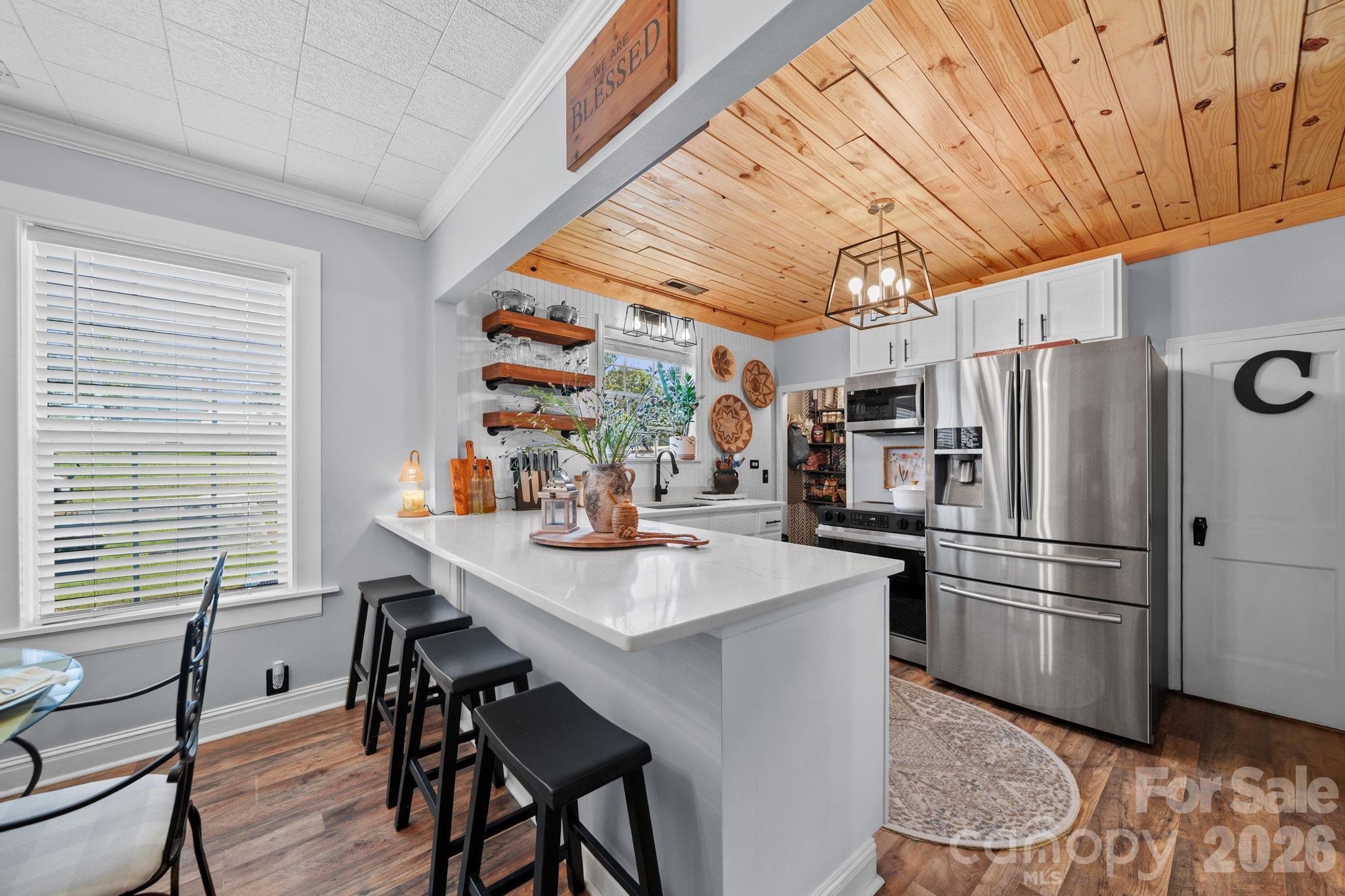 9215 Stokes Ferry Road Salisbury, NC 28146 - Photo 7 of 22 a kitchen with stainless steel appliances a refrigerator and a table
