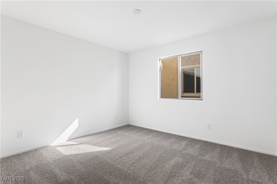 5678 Spring Trellis Street Las Vegas, NV 89113 - Photo 10 of 22 Unfurnished room featuring carpet floors and baseboards