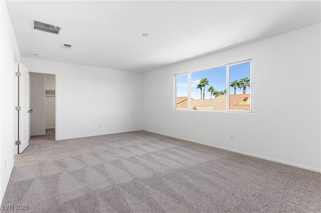 5678 Spring Trellis Street Las Vegas, NV 89113 - Photo 12 of 22 Unfurnished room with light colored carpet and baseboards