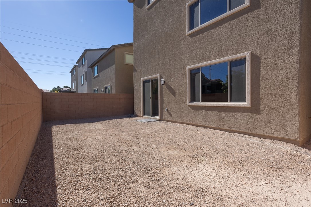 5678 Spring Trellis Street Las Vegas, NV 89113 - Photo 15 of 22 Rear view of property featuring stucco siding and a fenced backyard