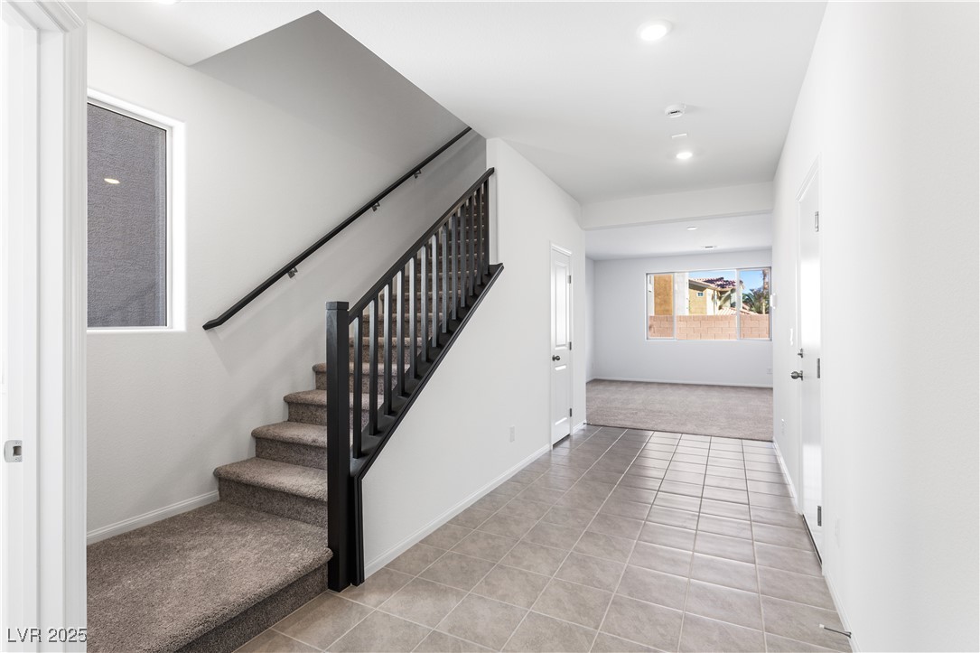 5678 Spring Trellis Street Las Vegas, NV 89113 - Photo 2 of 22 Staircase featuring tile patterned floors, recessed lighting, and carpet floors