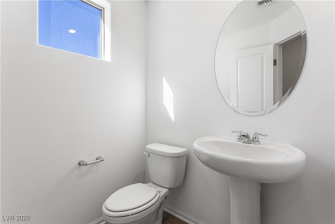 5678 Spring Trellis Street Las Vegas, NV 89113 - Photo 3 of 22 Bathroom with toilet and baseboards