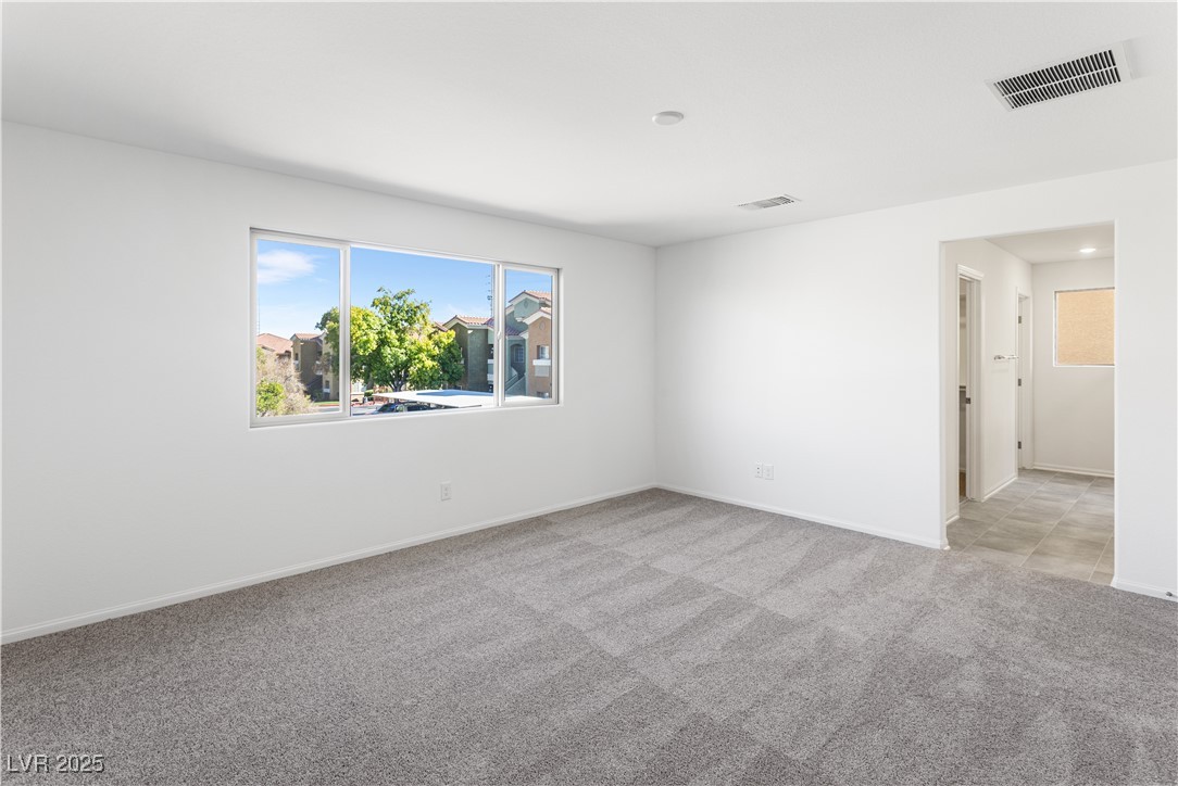 5678 Spring Trellis Street Las Vegas, NV 89113 - Photo 6 of 22 Spare room with light carpet and baseboards