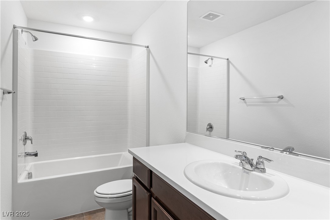 5678 Spring Trellis Street Las Vegas, NV 89113 - Photo 8 of 22 Full bathroom featuring vanity, shower / tub combination, and light tile patterned floors